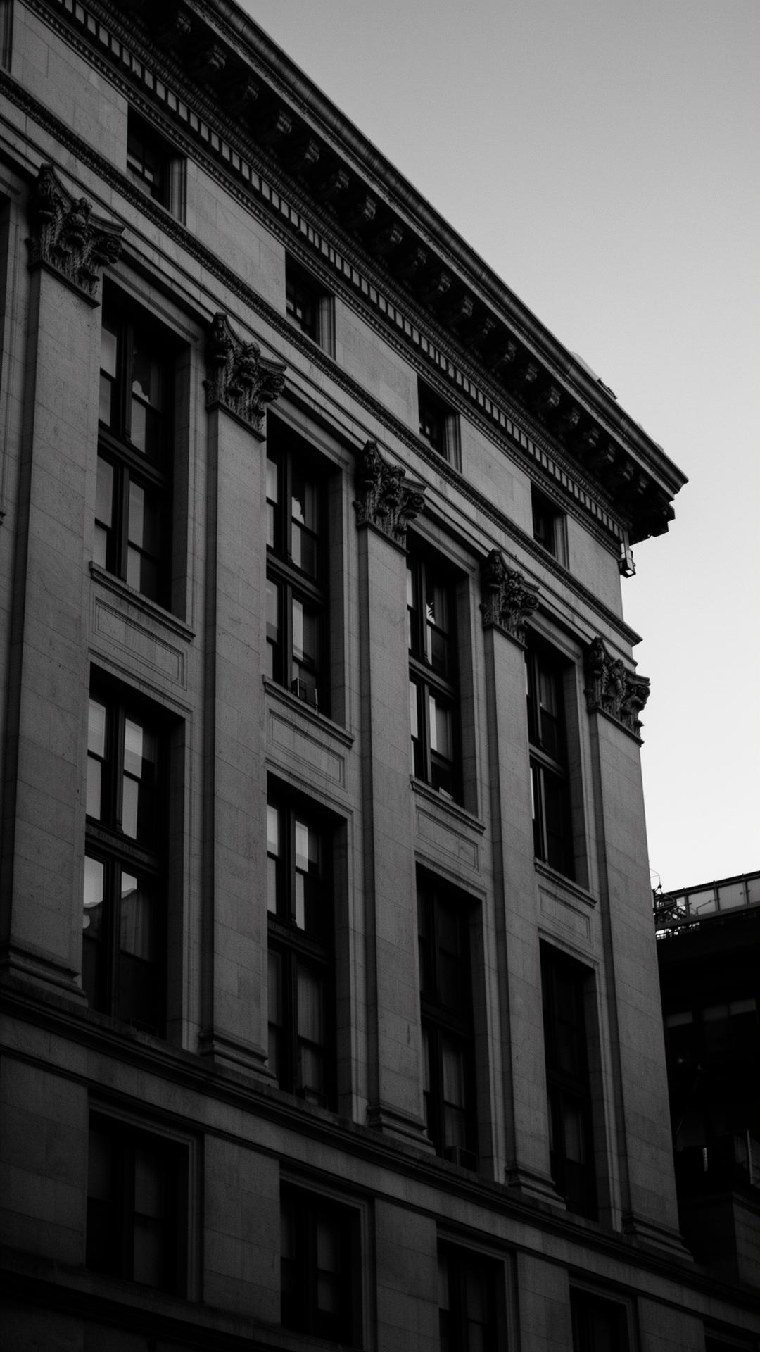 Limestone arched facade of a New York City multi-family building Asured Insurance helps cover